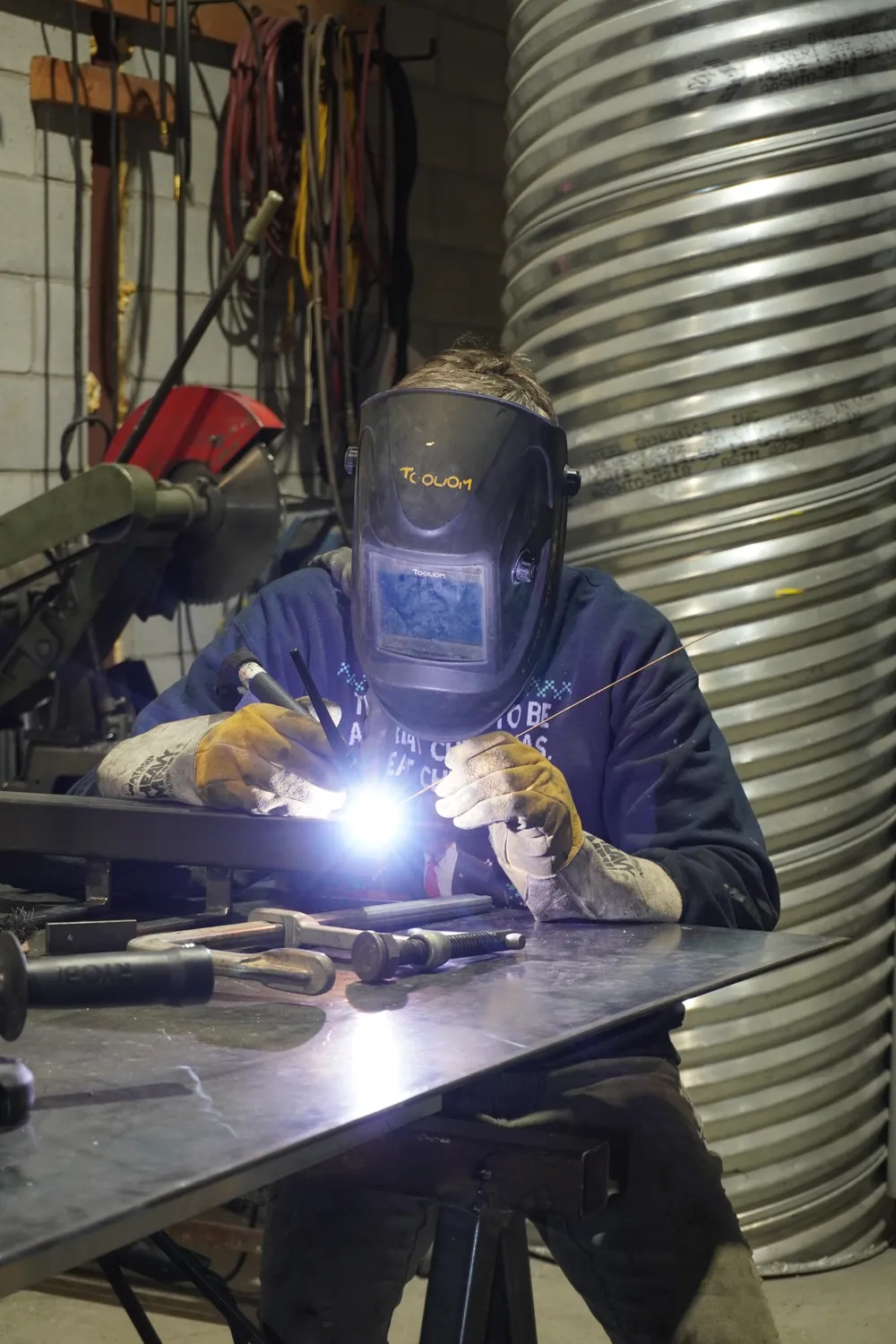 PacoMetal welder at work, helmet down